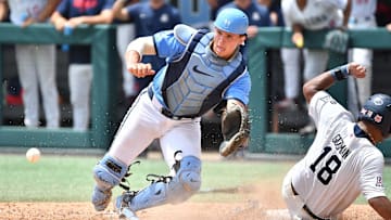 Arizona's Adonys Guzman (18) slides into home plate to score beating the throw to North Carolina catcher Luke Stevenson (44) . The North Carolina Tar Heels and the Arizona Wildcats met in game two of the NCAA Division 1 Super Regionals in Chapel Hill, N.C. on June 7, 2025.