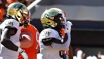 Oct 4, 2025; Blacksburg, Virginia, USA;  Wake Forest Demon Deacons running back Kalil Townes (0) gestures toward the crowd after scoring a touchdown against the Virginia Tech Hokies during the second quarter at Lane Stadium. Mandatory Credit: Brian Bishop-Imagn Images