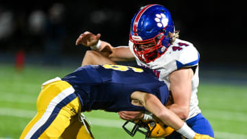 Mason's Logan Doerr, right, tackles Trenton's Austin Toth during the second quarter on Friday, Nov. 11, 2022, at Trenton High School.