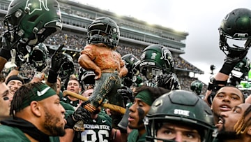 Michigan State celebrates with the Paul Bunyan Trophy after beating Michigan on Saturday, Oct. 30, 2021, at Spartan Stadium in East Lansing.