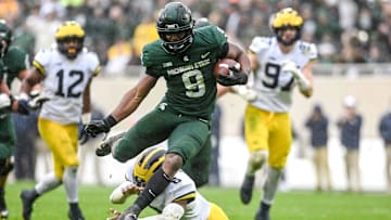 Michigan State's Kenneth Walker III avoids a tackle by Michigan's R.J. Moten during his touchdown run during the fourth quarter on Saturday, Oct. 30, 2021, at Spartan Stadium in East Lansing.

Syndication Lansing State Journal