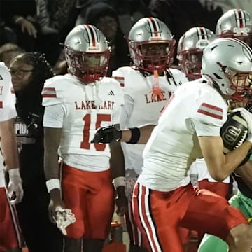 Lake Mary's Barrett Schulz (4) catches the ball down the field and scores a touchdown against DeLand in the Region 1-7A finals, Friday, Nov. 28, 2025, at Spec Martin Stadium.