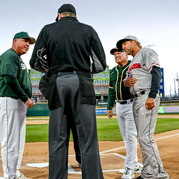 Michigan State's head coach Jake Boss Jr., left, Athletics scout Rich Sparks, center, and Lugnuts' manager Craig Conklin, right, meet with the umpire on Tuesday, April 4, 2023, before the Crosstown Showdown at Jackson Field in Lansing.

230404 Msu Lugnuts Bsball 011a