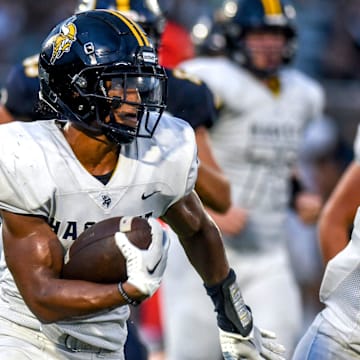Haslett's Kory Amachree runs for a gain against DeWitt during the second quarter on Thursday, Aug. 24, 2023, at DeWitt High School.