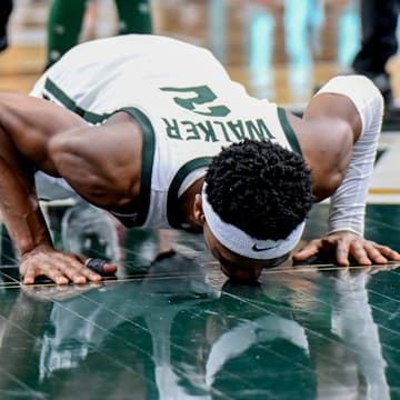 Michigan State senior Tyson Walker kisses the Spartans logo at mid-court during the senior night celebration after the game against Northwestern on Wednesday, March 6, 2024, at the Breslin Center in East Lansing.