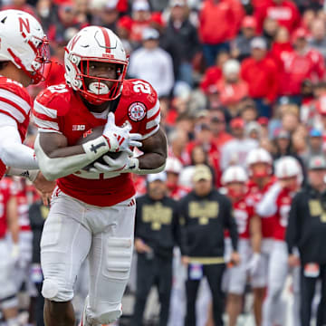 Nebraska running back Emmett Johnson takes a handoff from quarterback Dylan Raiola against Northwestern.