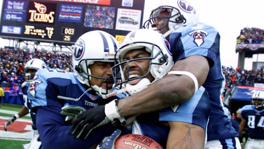 Tennessee Titans wide receiver Kevin Dyson, center, holds onto the ball as he is celebrates with teammates Yancey Thigpen.