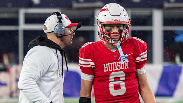 Hudson head coach Zac Attaway talks with his quarterback and son Jake Attaway during their championship game against Fairhave