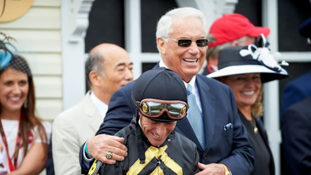 Trainer D. Wayne Lukas stands beside jockey Gary Stevens in the winner’s circle after Oxbow’s victory at the 2013 Preakness.