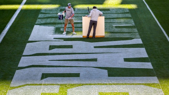 Michigan State University Assistant Sports Turf Manager Brian McDougal, left, and student assistant