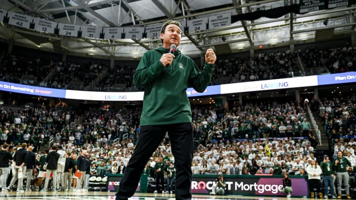 Michigan State's new football coach Jonathan Smith speaks to the crowd during a timeout in the