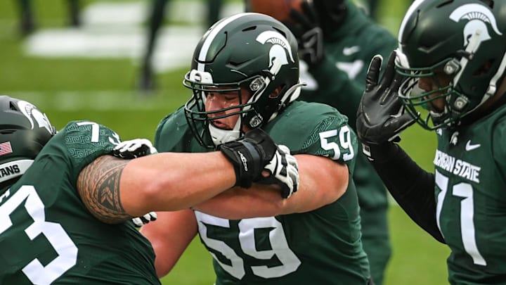 Michigan State's Nick Samac, right, warms up with teammate Jacob Isaia before the game against Ohio