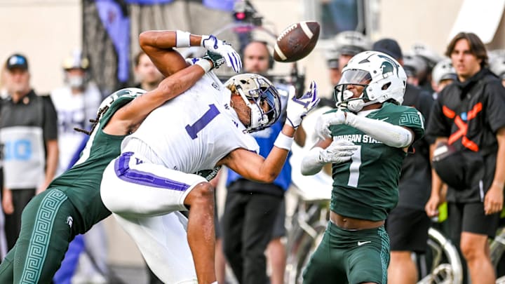 Michigan State's Marqui Lowery Jr., left, and Jaden Mangham break up a pass against Washington's