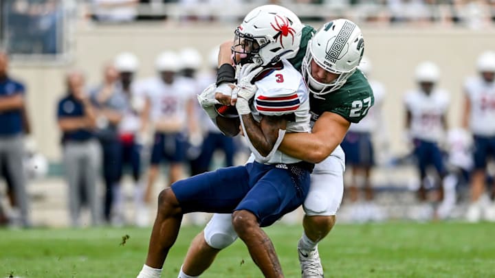 Michigan State's Cal Haladay, right, tackles Richmond's Quanye Veney during the first quarter on Saturday, Sept. 9, 2023, at Spartan Stadium in East Lansing.