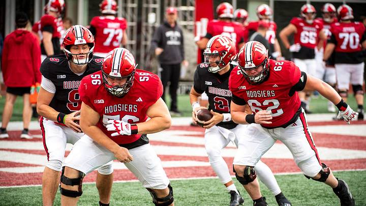 Indiana's Mike Katic (56) and Drew Evans (62) work through a drill during practice at Memorial Stadium on Tuesday, March 26, 2024.