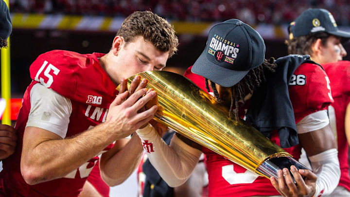 Indiana's Fernando Mendoza (15) an D'Angelo Ponds (5) kiss the trophy after the College Football Playoff National Championship college football game at Hard Rock Stadium in Miami Gardens on Monday, Jan. 19, 2026.