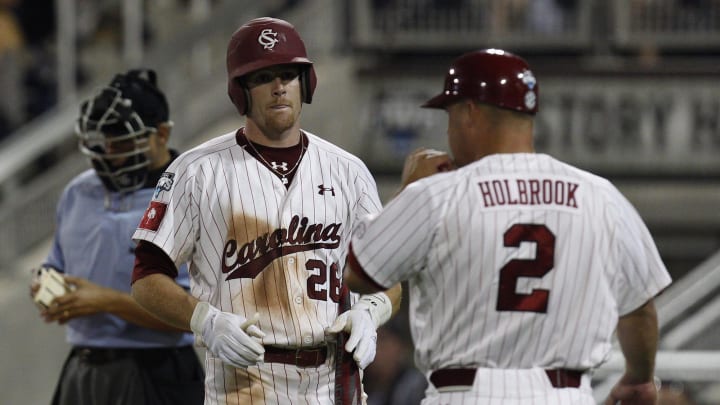 Former South Carolina baseball head coach Chad Holbrook speaking with outfielder Adam Matthews when he was an assistant with the Gamecocks