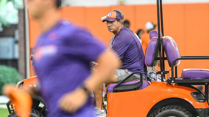 Clemson head coach Dabo Swinney rides in a golf cart as practice was moved indoors with lightning in the area, during the 2024 Dabo Swinney Football Camp in Clemson in Clemson June 5, 2024.