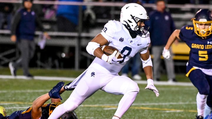 East Lansing's Jace Clarizio runs for a gain against Grand Ledge during the first quarter on Friday, Oct. 20, 2023, at Grand Ledge High School.