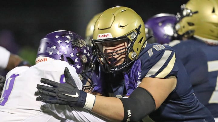 Hoban offensive lineman Sam Greer (right) blocks Barberton linebacker Micryn Miller in a Division II regional quarterfinal, Friday, Nov. 3, 2023.