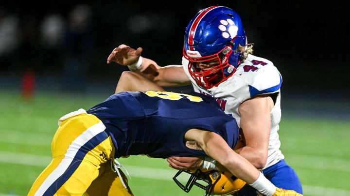 Mason's Logan Doerr, right, tackles Trenton's Austin Toth during the second quarter on Friday, Nov. 11, 2022, at Trenton High School.