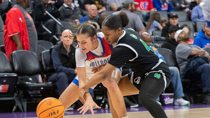 St. Mary's Nyah Buntun, right, fights for a loose ball with Folsom's Ella Uriarte during the Sac-Joaquin Section girls basketball championship game at Golden One Center in Sacramento on Feb. 21. 2024. St. Mary's won 57-51.