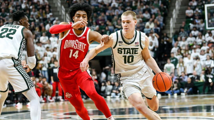 Michigan State's Joey Hauser, right, moves the ball as Ohio State's Justice Sueing defends during the second half on Saturday, March 4, 2023, at the Breslin Center in East Lansing.

230304 Msu Ohio State 117a