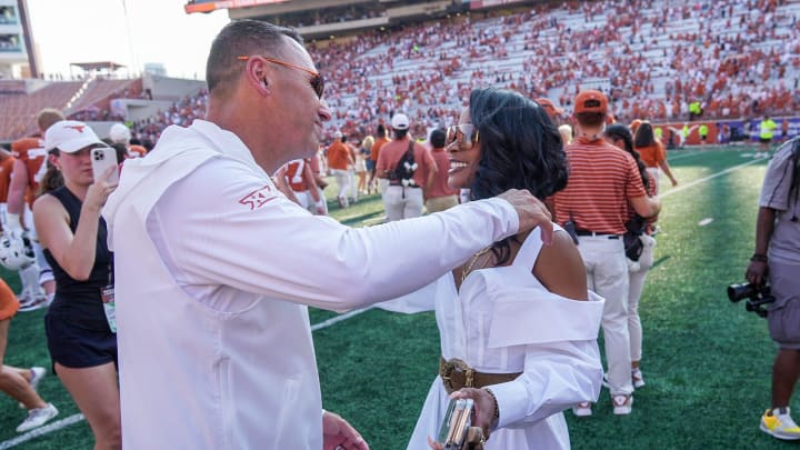 Texas Longhorns head coach Steve Sarkisian hugs and kisses his wife Loreal Sarkisian after the NCAA college football game, Saturday, Sept. 2, 2023, in Austin, Texas.