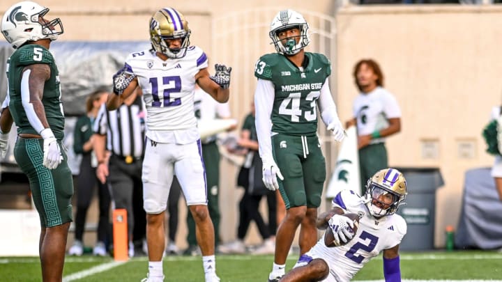 Washington's Ja'Lynn Polk, right, scores as Michigan State defenders Jordan Hall, left, and Malik Spencer (43) react during the second quarter on Saturday, Sept. 16, 2023, at Spartan Stadium in East Lansing.