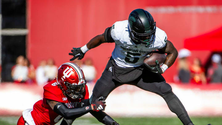 Indiana's Phillip Dunnam (6) tackles Michigan State's Nate Carter (5) during the first half of the Indiana versus Michigan State football game at Memorial Stadium on Saturday, Nov. 18, 2023.