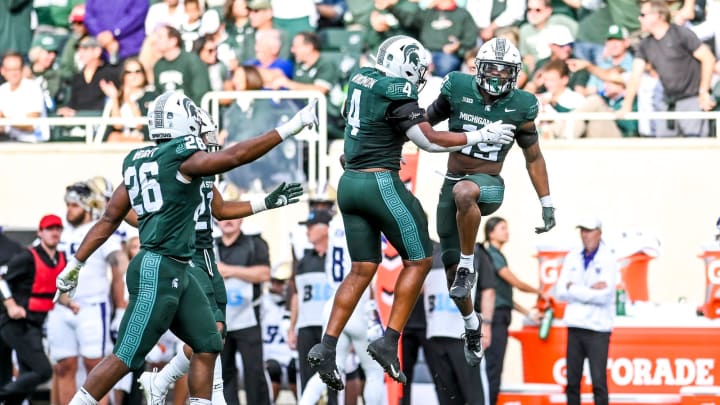 Michigan State's Armorion Smith, right, celebrates after nearly intercepting a Washington ball on third down during the first quarter on Saturday, Sept. 16, 2023, at Spartan Stadium in East Lansing.