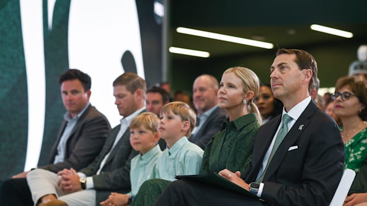 Michigan State Univeristy Athletic Director J Batt, right, listens to MSU basketball coach Tom Izzo, Wednesday, June 4, 2025, before being introduced to the Spartan community as the new athletic director. Seated next to Batt is wife Leah, and sons Fitzgerald and Graham.