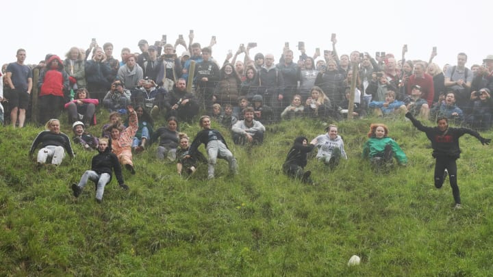 Contestants chasing cheese down Cooper’s Hill during 2022's Cheese-Rolling contest.