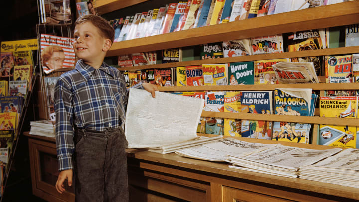 A child is pictured next to comic books