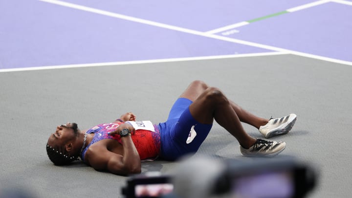 Noah Lyles rests after winning bronze in the 200m at the Paris Games. It was revealed he had tested positive for COVID.