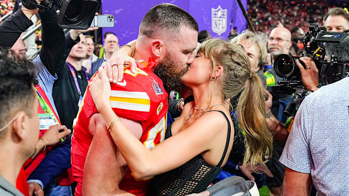 Travis Kelce kisses his then-girlfriend Taylor Swift following victory in Super Bowl LVIII.