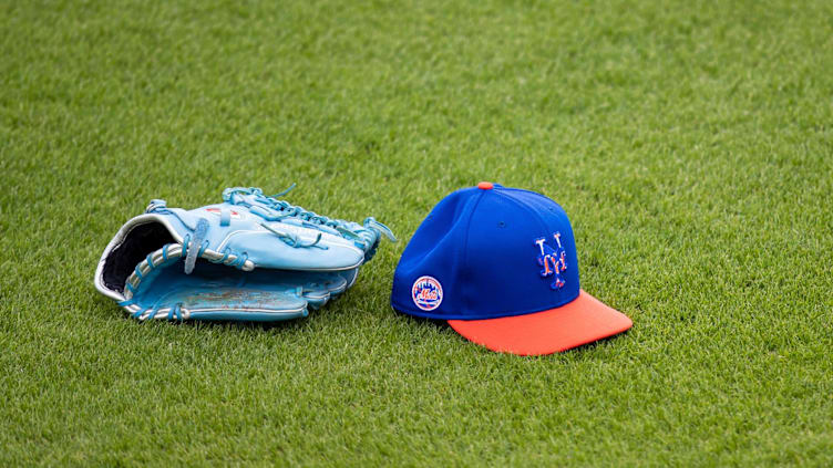 Feb 22, 2021; Port St. Lucie, Florida, USA; The hat and glove of New York Mets starting pitcher