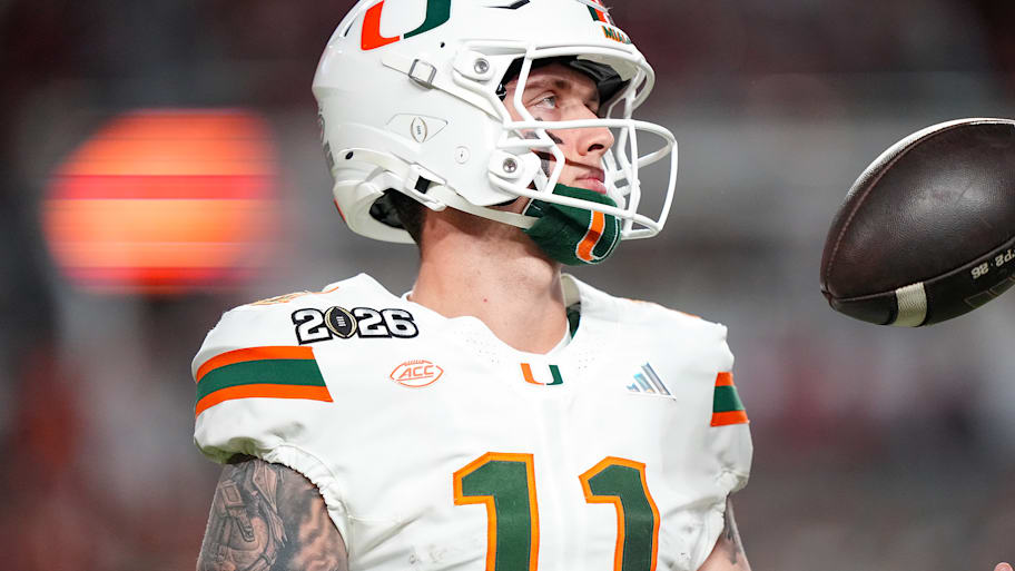 Miami quarterback Carson Beck tosses a boll in the air.