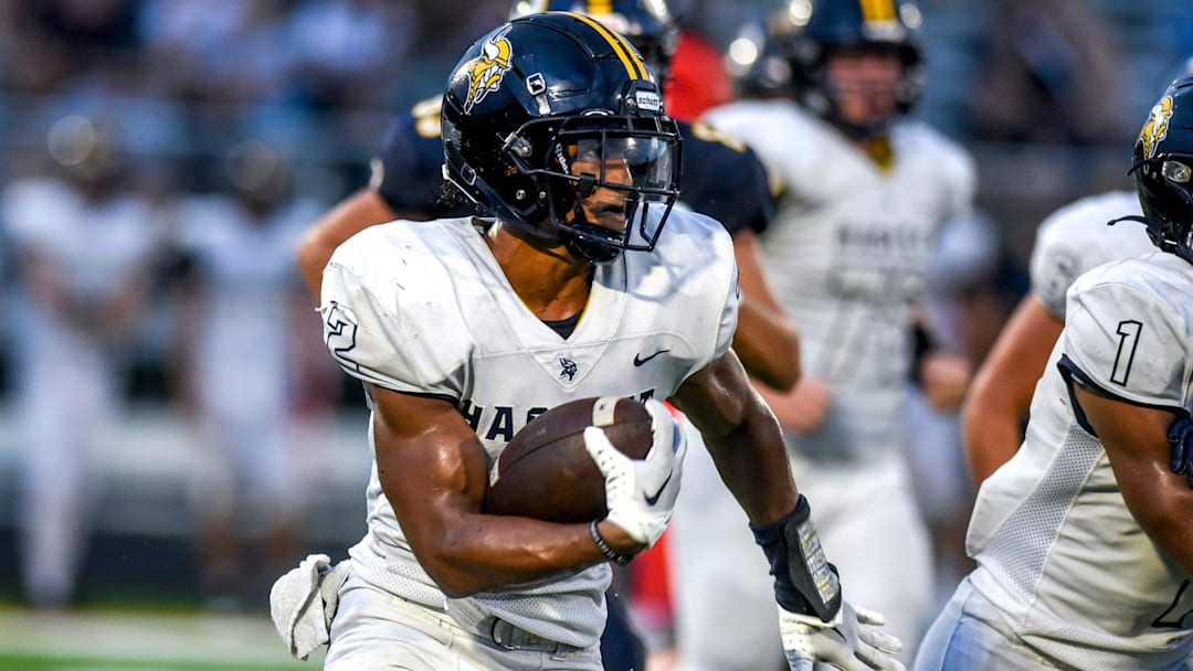 Haslett's Kory Amachree runs for a gain against DeWitt during the second quarter on Thursday, Aug. 24, 2023, at DeWitt High School.