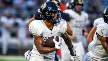 Haslett's Kory Amachree runs for a gain against DeWitt during the second quarter on Thursday, Aug. 24, 2023, at DeWitt High School.