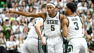 Michigan State's Tre Holloman, center, gets back on defense after a 3-pointer against Iowa during