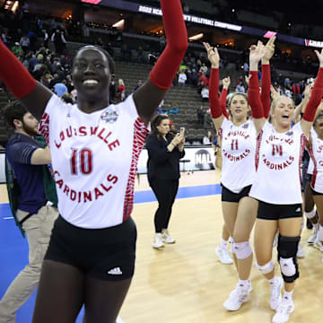 Louisville Volleyball players celebrate