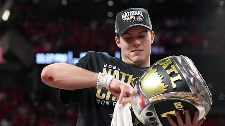 Will Howard admires a jumbo championship ring after the Buckeyes won the national championship. Will Howard admires a jumbo championship ring after the Buckeyes won the national championship.