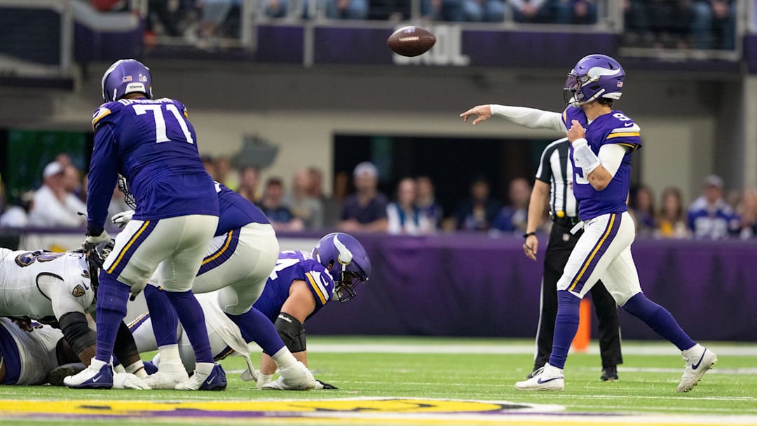 Vikings left tackle Christian Darrisaw (71) blocking for quarterback J.J. McCarthy (9). 