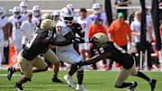 Sep 20, 2025; Blacksburg, Va.; Wofford attempts to tackle Virginia Tech running back Marcellous Hawkins (27) as he runs the ball.
