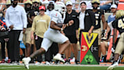 Sep 20, 2025; Blacksburg, Virginia, USA;  Virginia Tech Hokies quarterback Kyron Drones (1) runs the ball during the third quarter against the Wofford Terriers at Lane Stadium. Mandatory Credit: Brian Bishop-Imagn Images