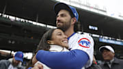 Chicago Cubs shortstop Dansby Swanson hugs his wife, Chicago Stars forward Mallory Swanson, on opening day at Wrigley Field on March 30, 2023, in Chicago.