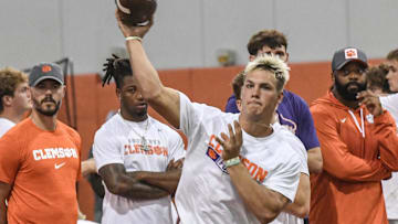 Tait Reynolds, Class of 2026 Pro style quarterback from Queen Creek, Arizona passes near Clemson offensive coordinator Garrett Riley, left, during the 2024 Dabo Swinney Football Camp in Clemson in Clemson June 5, 2024.