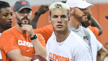Tait Reynolds, Class of 2026 Pro style quarterback from Queen Creek High in Arizona passes near Clemson offensive coordinator Garrett Riley, left, during the 2024 Dabo Swinney Football Camp in Clemson in Clemson June 5, 2024.