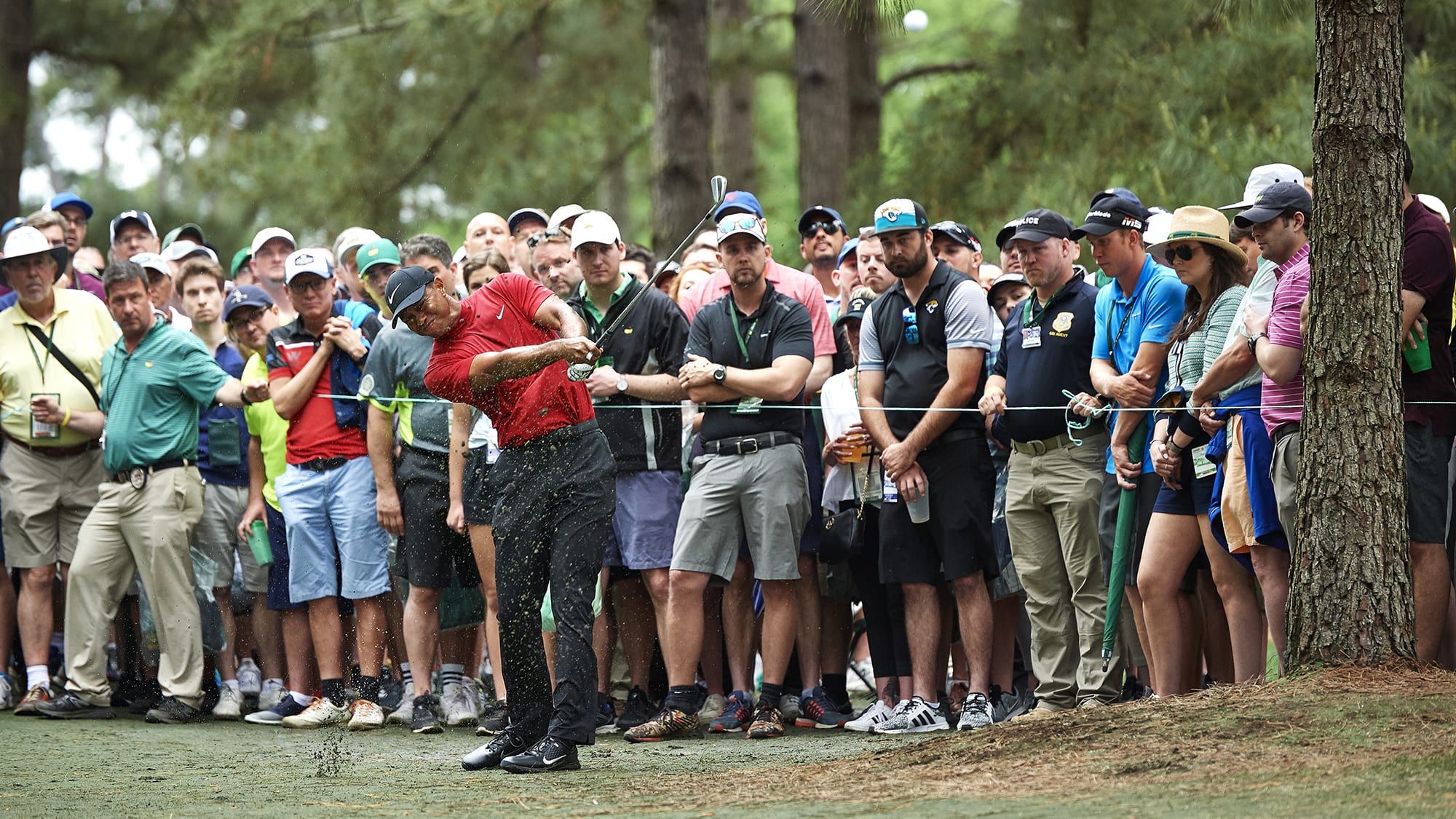 Tiger Woods hits shot at 2019 Masters in front of patrons.